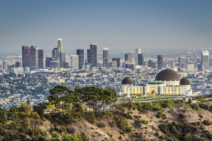 the los angeles skyline is shown in this aerial view from the top of a hill