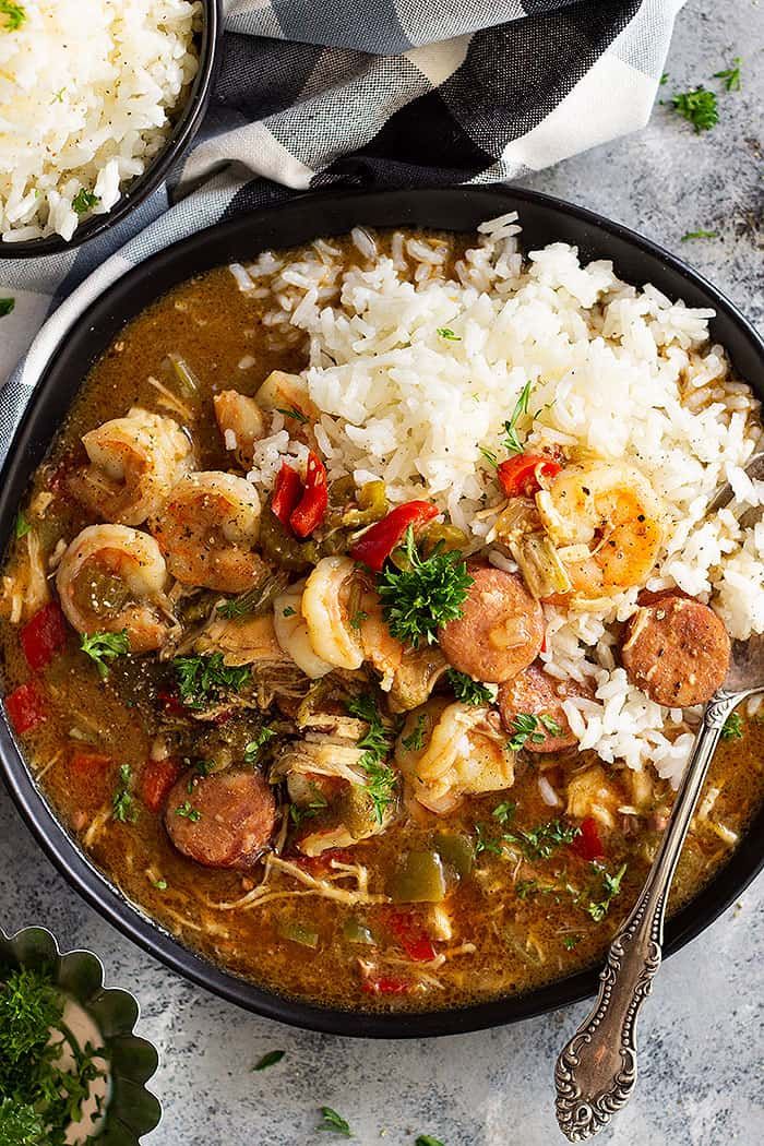 two bowls filled with shrimp and rice on top of a table