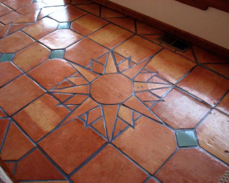 a bathroom floor that has been painted with different colors and designs on it, including the sun