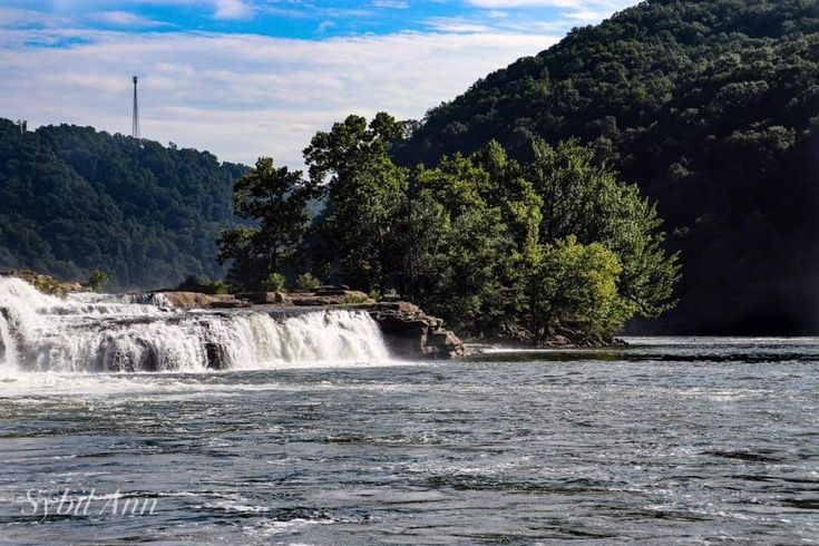 a large waterfall in the middle of a lake