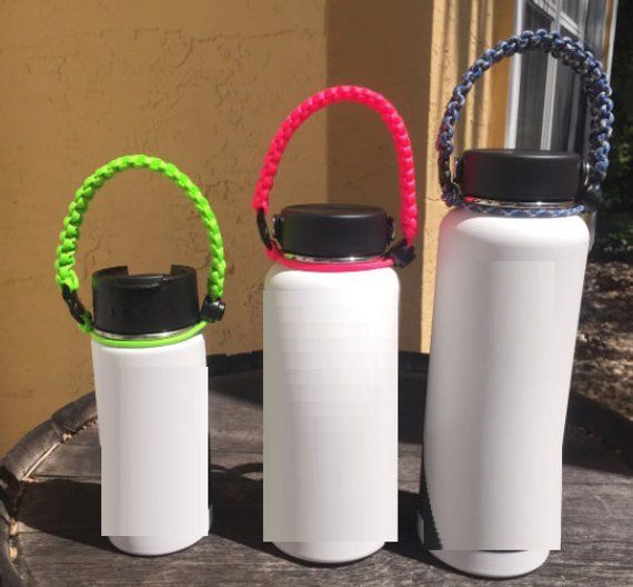 three water bottles sitting on top of a wooden table