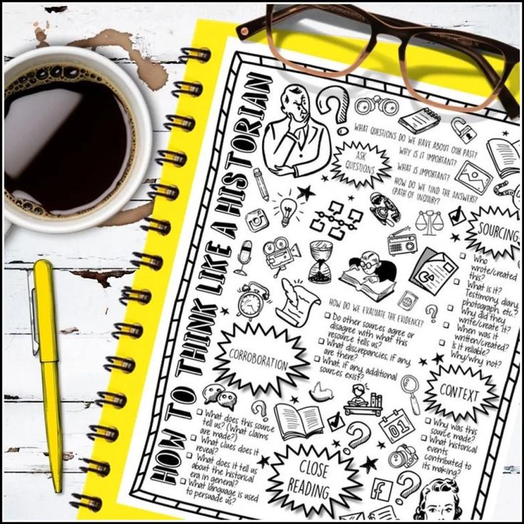 an open notebook on top of a table next to a cup of coffee and eyeglasses