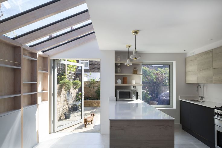 an open kitchen and dining area with skylights