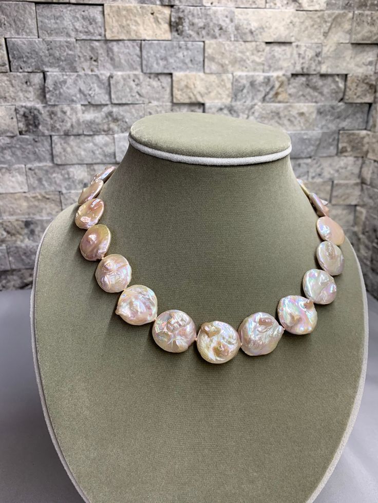 "Light Apricot Rose Baroque Coin Pearl Necklace. This hand knotted strand features 20 Light Apricot Freshwater Coin Pearls Baroque AAA High Luster unique large round shapes with amazing iridescent rainbow overtones. These pearls were nicknamed \"Moon Landing\" pearls by the wholesaler 19.3 - 19.9 mm Genuine and Natural in Color they have little mabe bumps in the nacre, very organic and unique. I hand knotted these with white silk thread and finished it with a pretty 925 silver toggle clasp 23mm Round Pearl Necklace With Gemstone Beads, Round Pearl Beaded Necklaces, Beaded Mother Of Pearl Round Necklaces, Round Pearl Beaded Necklaces With Gemstone Beads, Pearl Beaded Necklaces With Gemstone Beads, Elegant Iridescent Adjustable Necklace, Elegant Adjustable Iridescent Necklaces, Elegant Iridescent Adjustable Necklaces, Adjustable Iridescent Round Necklaces