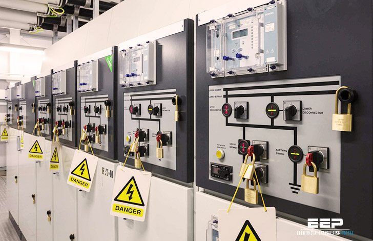 electrical panel with warning signs on them in an industrial building or factory area, including switches and controls