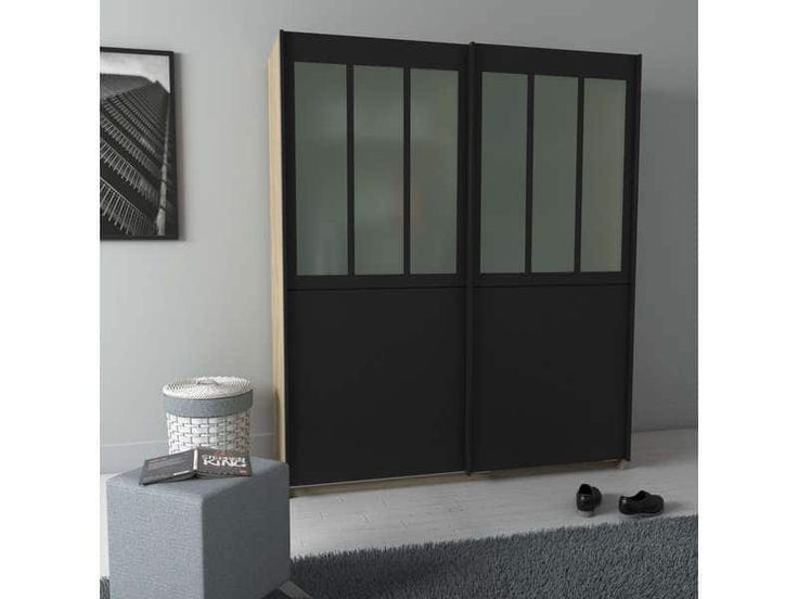 a black sliding door in a living room next to a gray ottoman and grey rug