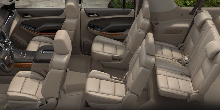 the interior of a car with four rows of seats