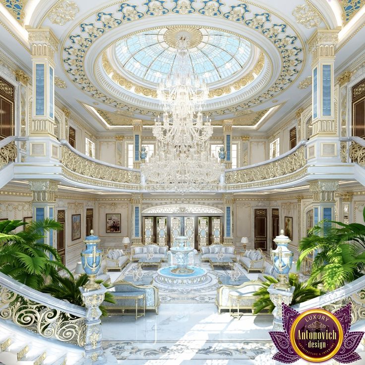 an ornately decorated living room with chandelier and couches in the center