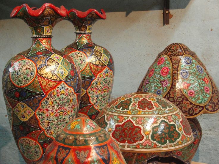 three large vases and two smaller ones with designs on them sitting next to each other