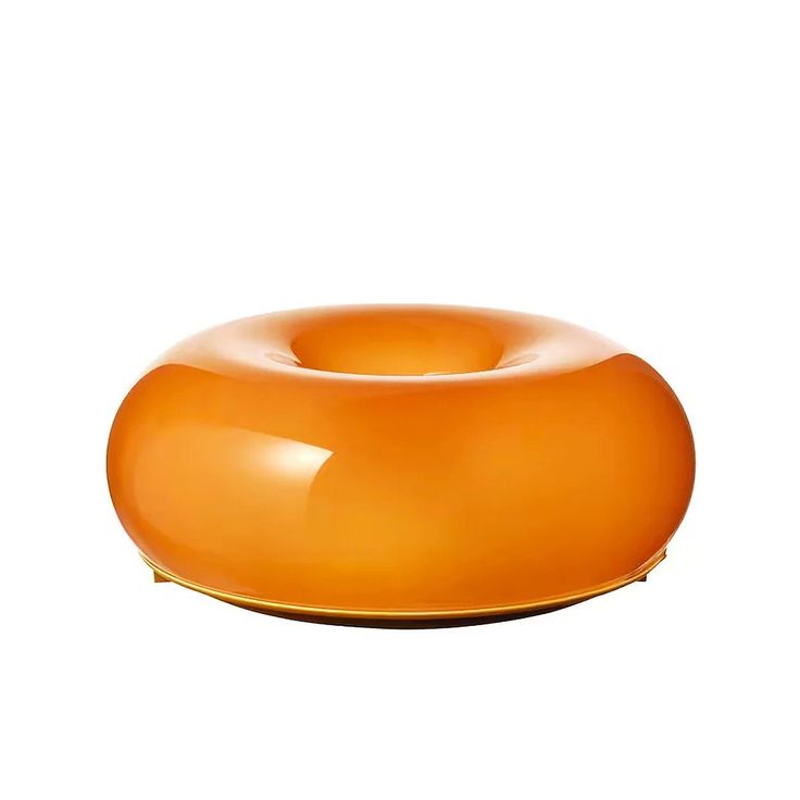 an orange object sitting on top of a white surface