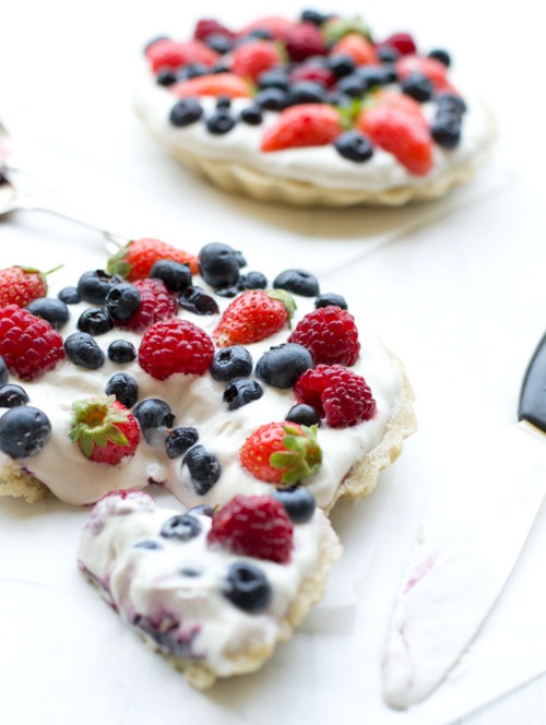 small pastries with berries and cream on a table