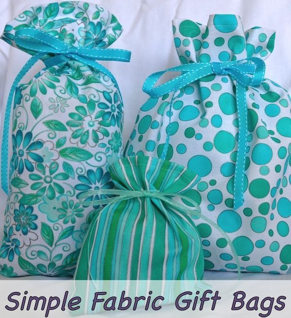 three bags with green and white designs on them, one has a blue ribbon around it