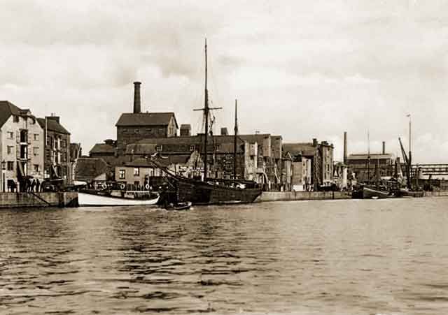 an old black and white photo of some boats in the water