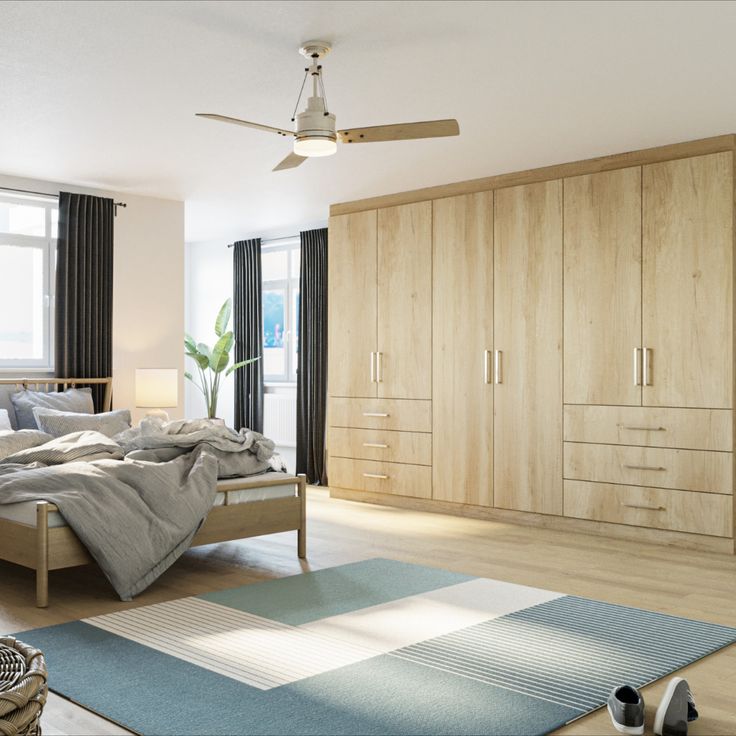 a bed room with a neatly made bed next to a dresser and a large window