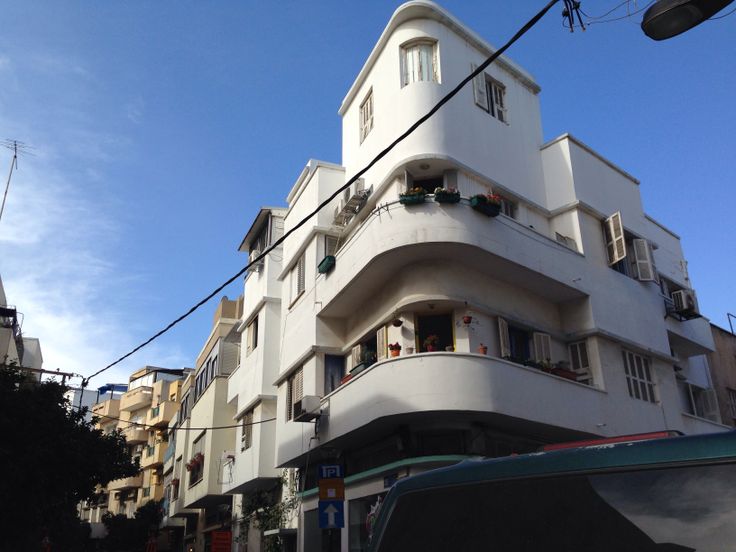 an apartment building with balconies on the second floor