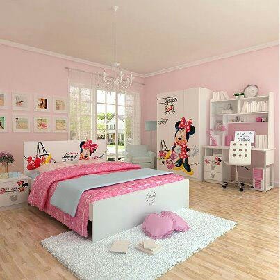 a bedroom decorated in pink and white with minnie mouse wall decals on the walls