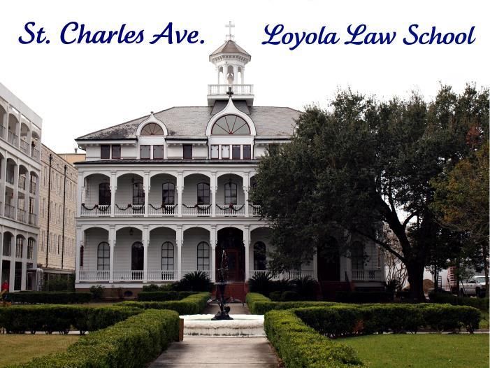 a large white building with a clock tower in the middle of it's front yard