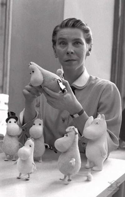 a woman is holding several stuffed animals in front of her face