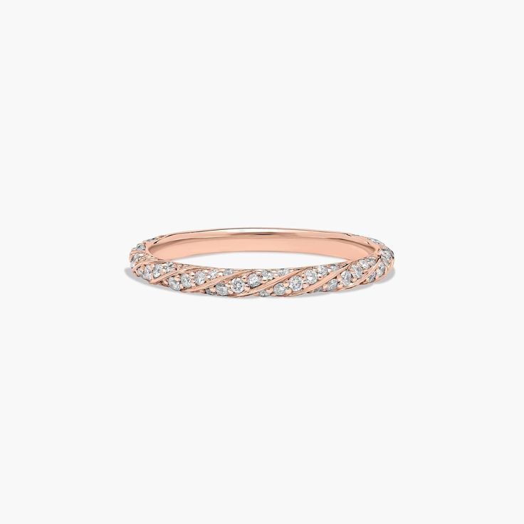 a rose gold band with white diamonds on the inside and outside, set against a plain background