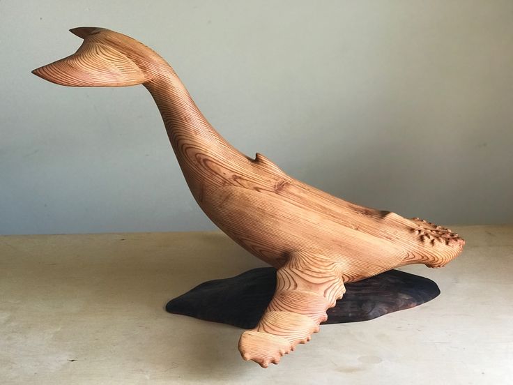 a wooden carved animal sitting on top of a table