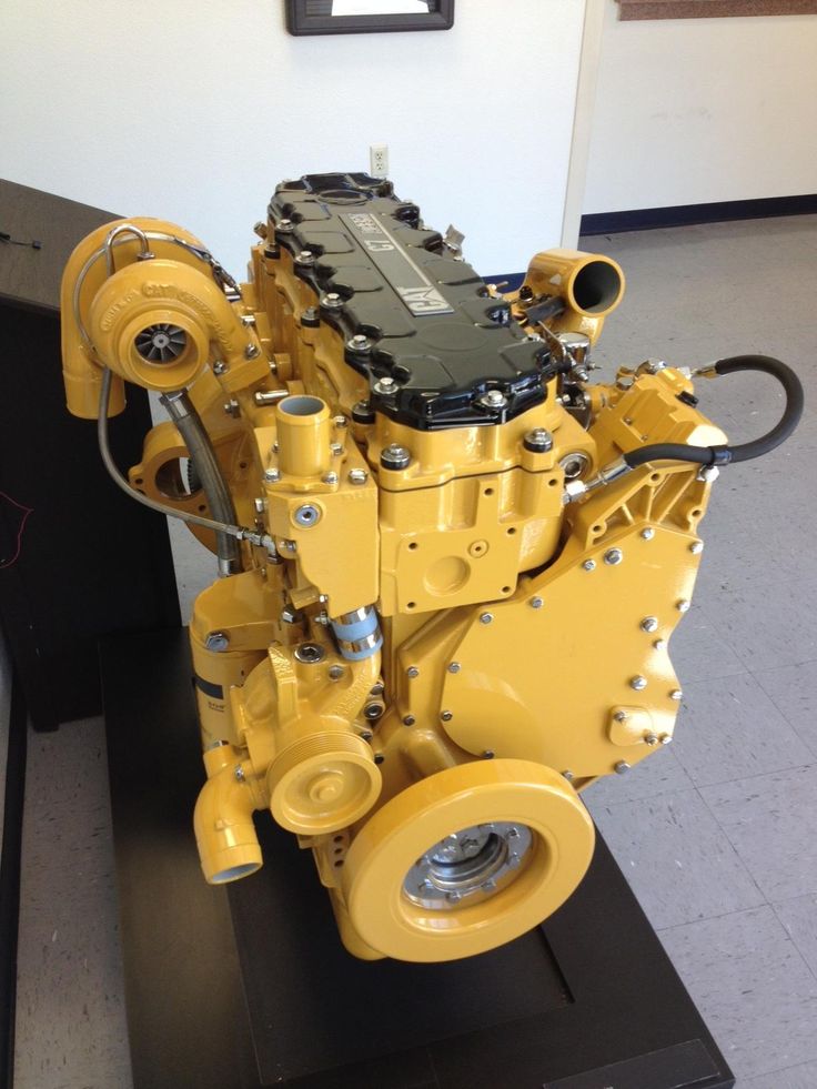 a yellow engine on display in a building