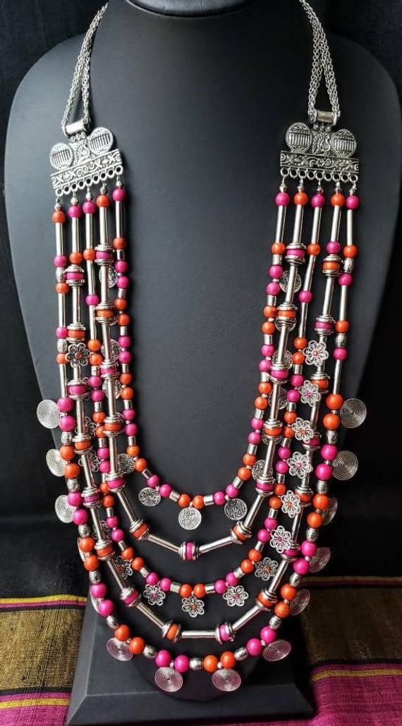 Gather compliments wearing this handcrafted multi strand colorful Afghani Kuchi coin necklace in a silver color. This is a LOT of necklace! Five strands. Outer row has stamped circular discs in an eternity pattern, middle row has adorable filigree flowers with colored centers, and the inner row has stamped discs resembling coins. Between each row is a row of beads separated by long tubular silver colored beads. Beads attach at the top to a beautiful peacock motif, and then a pretty chain. Lobste Oxidised Jewelry, Silver Indian Jewelry, Oxidized Jewellery, Peacock Motif, Diy Necklace Making, Diy Jewelry Set, Diy Fabric Jewellery, Oxidised Silver Jewelry, Belly Dance Jewelry