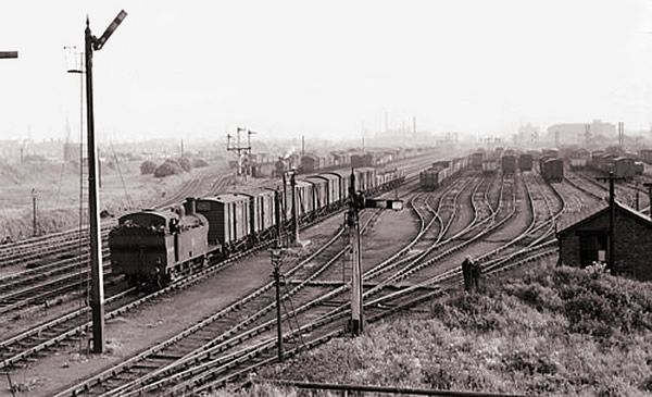 an old black and white photo of trains on train tracks in the country side,