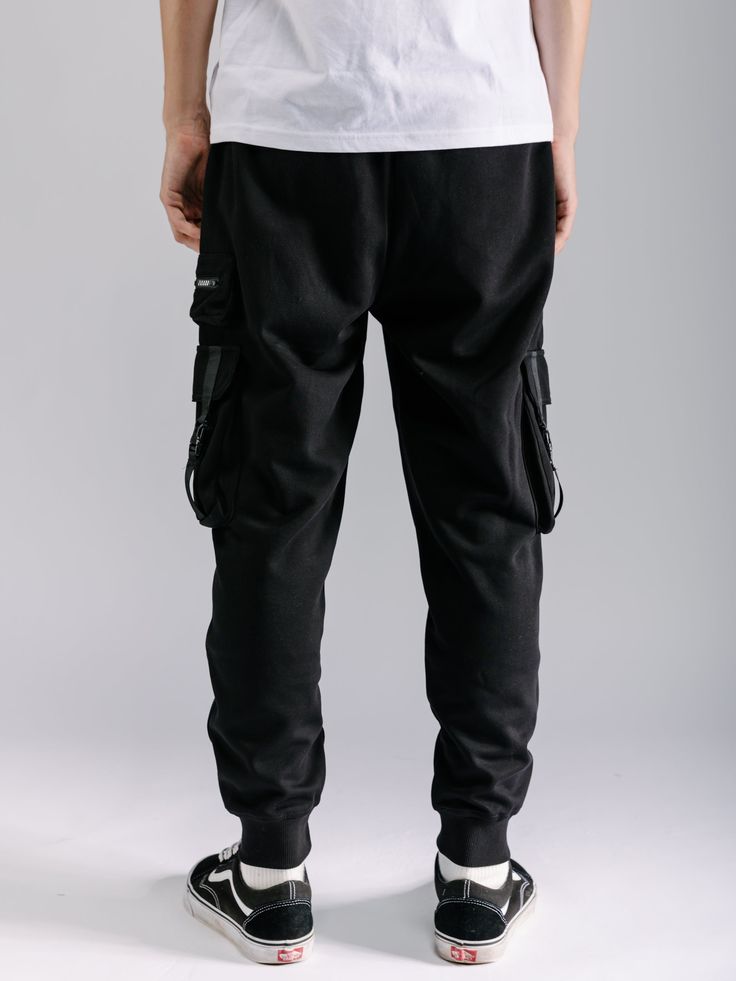 These Cargo Joggers are the perfect combination of practicality and comfort. With multiple pockets in a tactical style, you can easily store all your essentials while on the go. The soft fabric ensures all-day comfort, making these joggers a must-have for any outdoor enthusiast or busy individual. Machine wash cold, Tumble dry low, Wash with like colors, Do not bleach. Imported B4KP66 Size Chart Size XS S M L XL XXL Waist (inches) 25.5 - 27.5 27.5 - 29.5 29.5 - 31.5 31.5 - 33.5 33.5 - 35.5 35.5 Cotton Parachute Pants With Pockets For Sports, Baggy Sweatpants With Pockets For Outdoor Activities, Casual Black Cargo Pants With Multiple Pockets, Functional Sweatpants With Side Pockets, Black Casual Cargo Pants With Side Pockets, Baggy Functional Sports Bottoms, Techwear Sports Pants With Relaxed Fit, Techwear Pants With Relaxed Fit For Sports, Black Cotton Joggers With Multiple Pockets