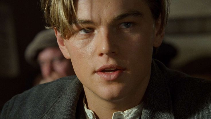 a close up of a person in a suit and tie looking at the camera with an intense look on his face