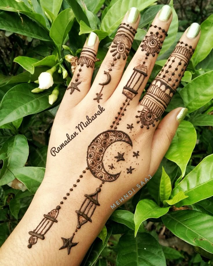 a woman's hand with henna tattoos on it