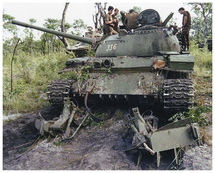 men standing on top of an old tank