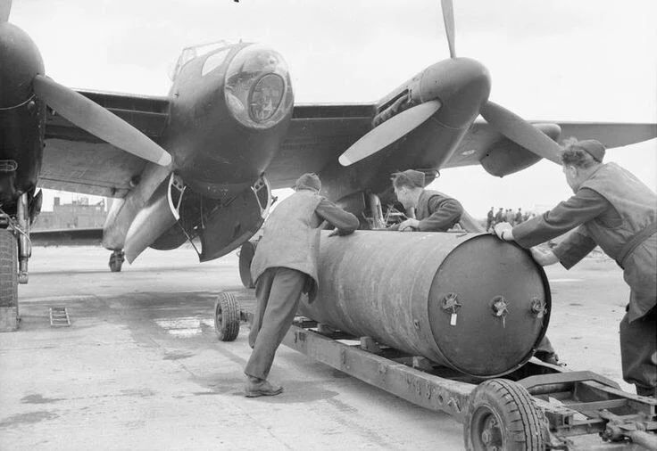 two men unloading barrels from an airplane