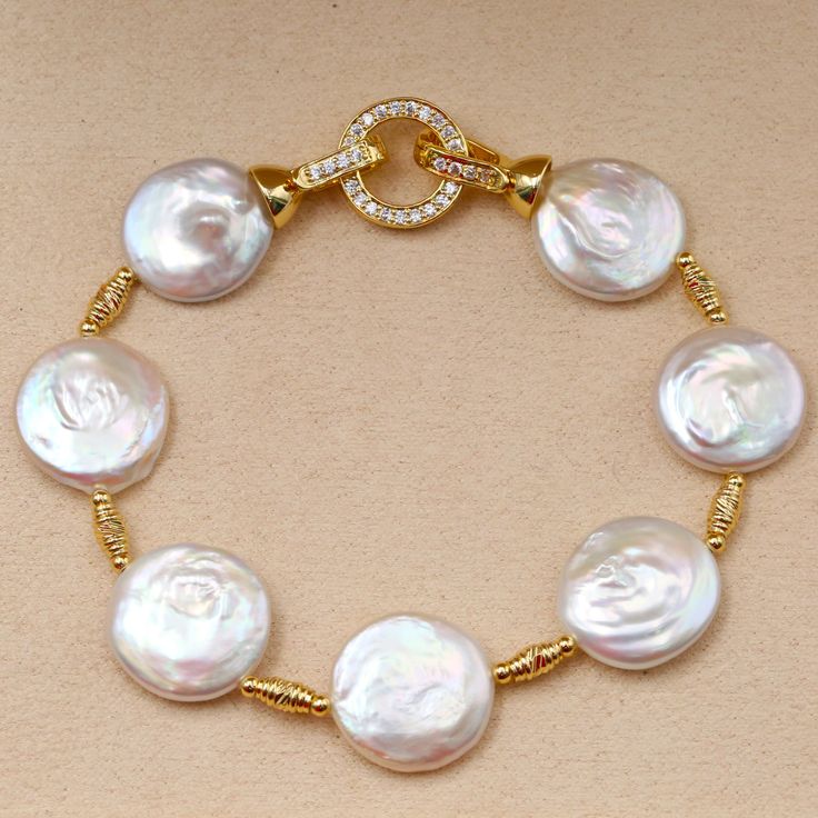 This gorgeous bracelet is a recent addition to Huge Tomato Jewelry and is sure to be a favorite for the upcoming holiday season. The pearl bracelet consists of 13-14mm AAAA GEM-quality baroque freshwater pearls with TOP luster. The bracelet is affixed with a beautiful rose gold clasp of your choice. Baroque Pearl Bracelet and Necklace 14K gold baroque pearl bracelet and necklace. Add a touch of elegance to any outfit with our collection of classic and handmade baroque pearl bracelet. The perfect Elegant Pearl Jewelry, Malachite Green, Pearl Necklace Designs, Bracelet And Necklace, Silver Pearl Necklace, Bracelet Wedding, Jewelry Mirror, White Pearl Necklace, Dainty Bracelet