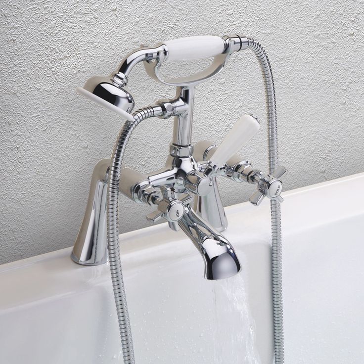 the faucet is attached to the bathtub with two hoses running from it