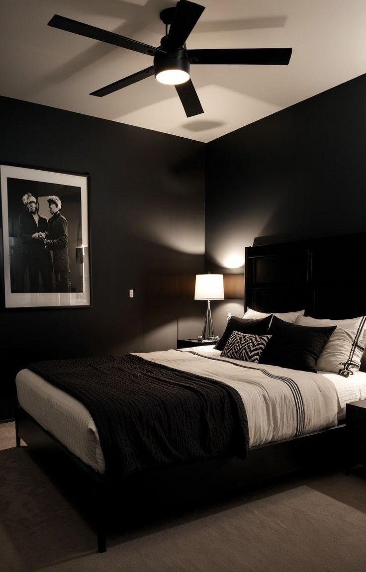 a black and white bedroom with a ceiling fan