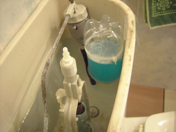 a bathtub filled with lots of water next to a faucet and soap dispenser