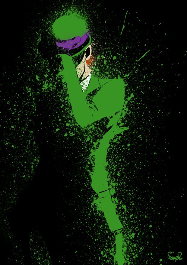 a man dressed in green and purple with his hands on his head, standing against a black background