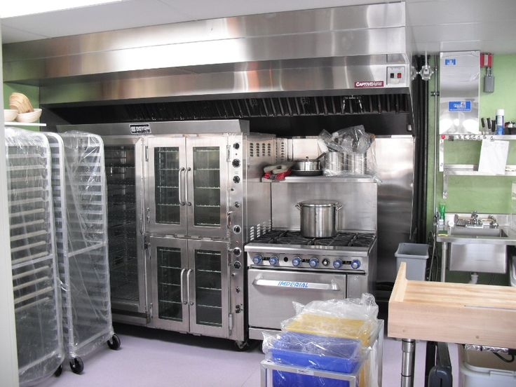 an industrial kitchen with stainless steel appliances