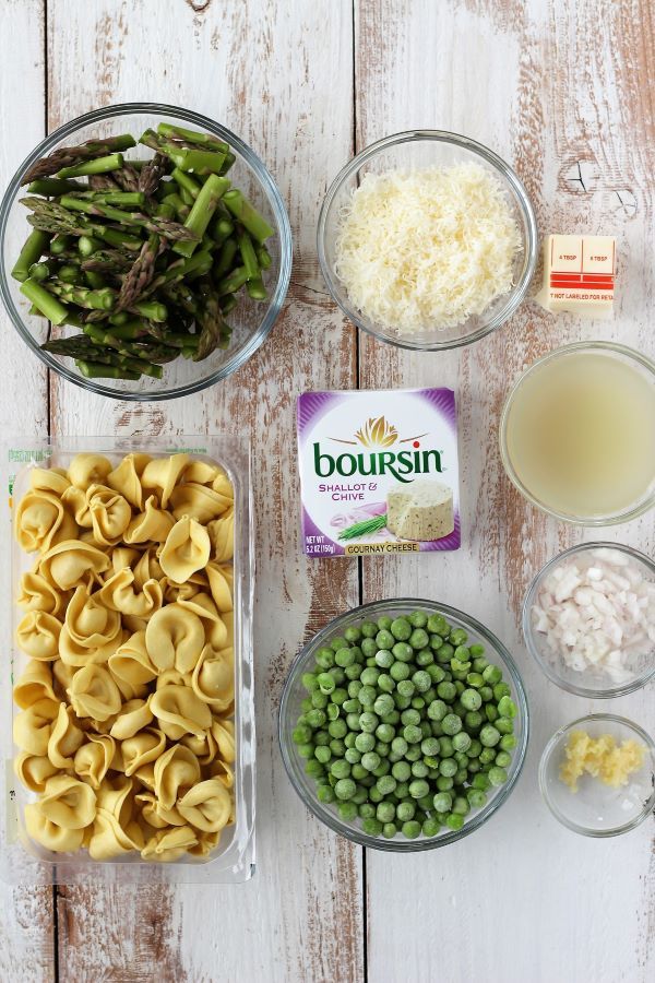 the ingredients to make this pasta dish include peas, green beans, and cheese in separate bowls