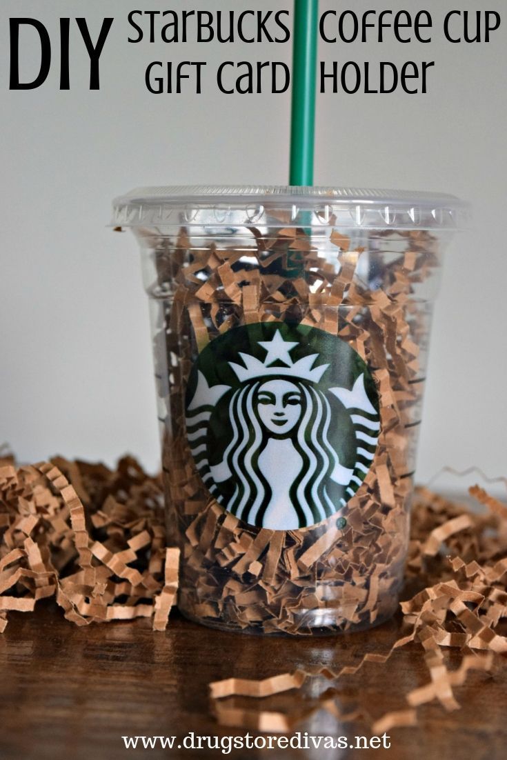 a starbucks cup filled with shredded paper on top of a table