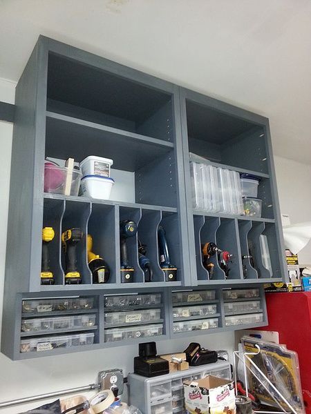 an organized workbench with tools and other items in the storage area, including screwdrivers