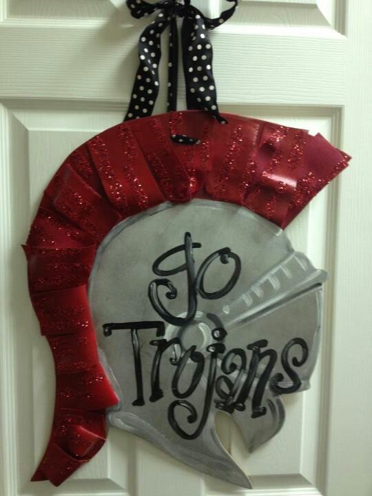 a door hanger with the words go tigers on it and a ribbon attached to it