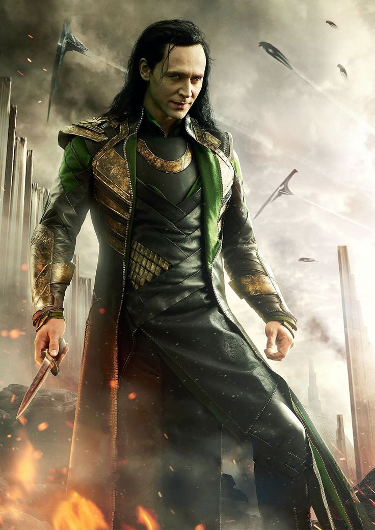 a man dressed as loki in front of an explosion of swords and fire with one hand on his hip