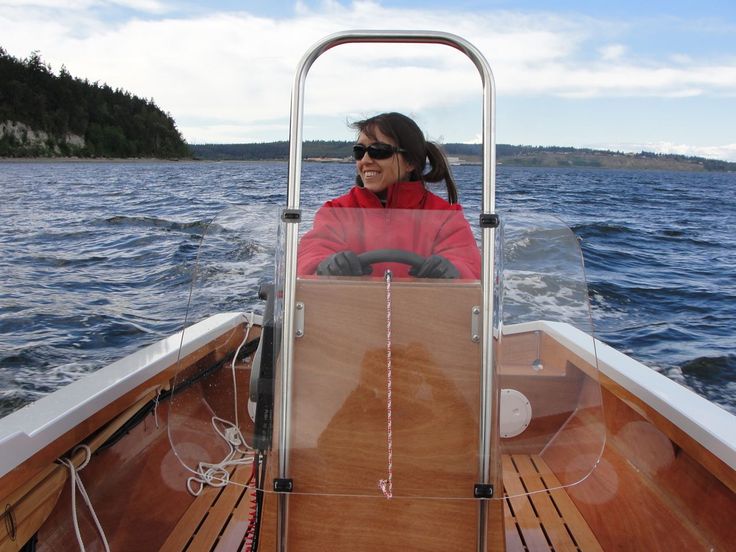 a woman sitting in the front seat of a boat