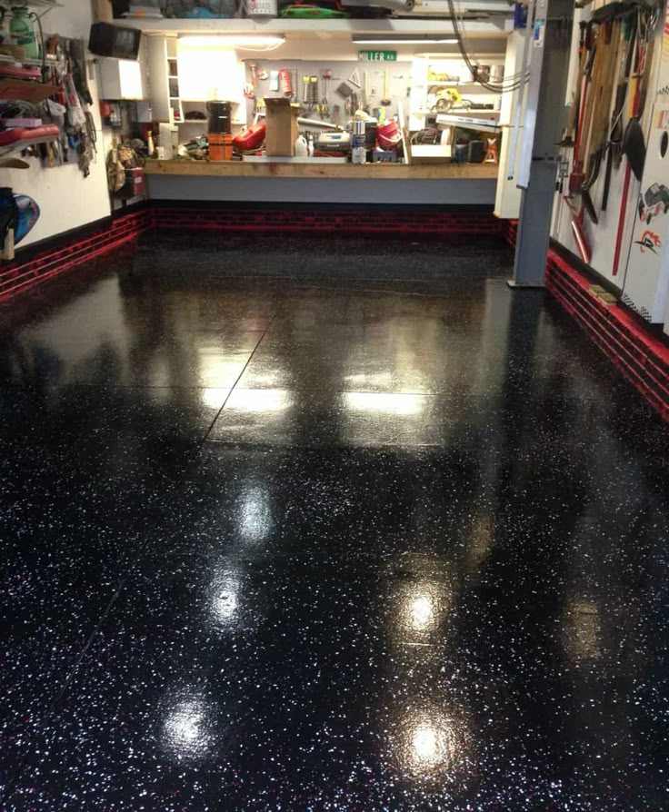 the inside of a garage with shiny black floors