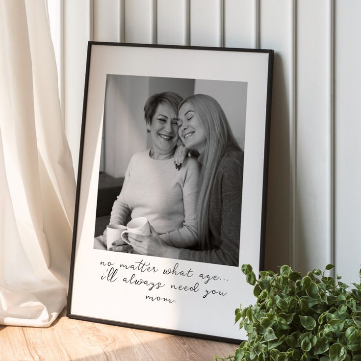 two women hugging each other in front of a framed photo with the words, no matter what age it'll always need you mom