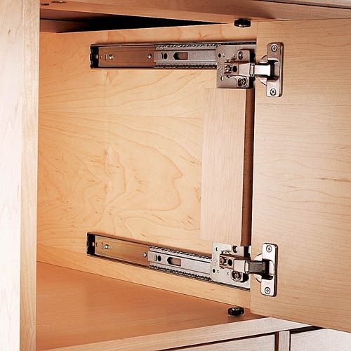 an open cabinet door with metal latches on it