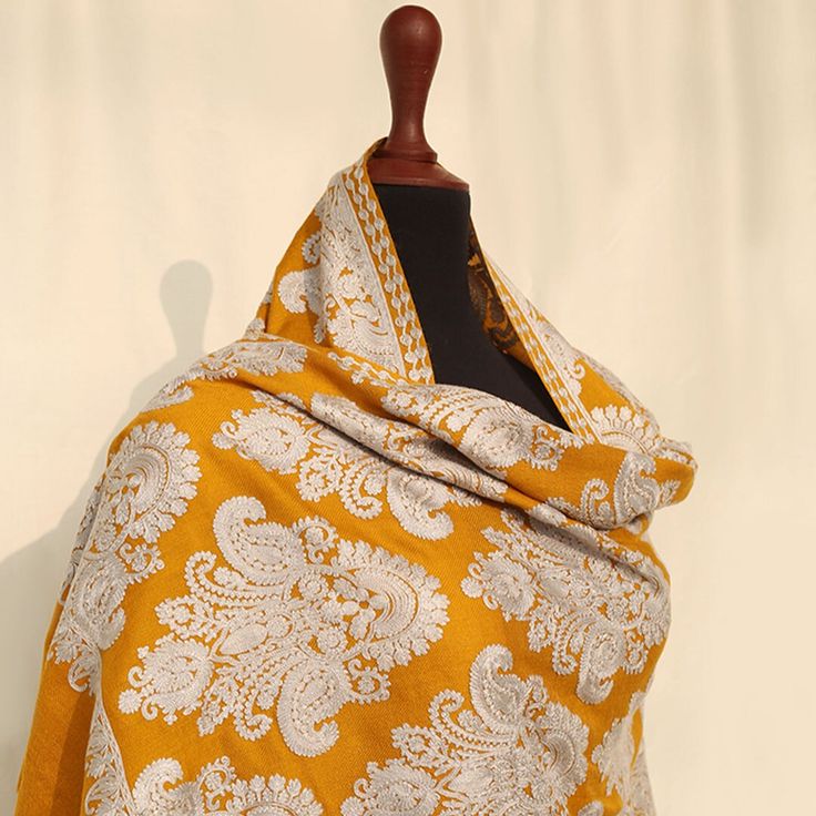 Mustard Embroidered Kashmiri pashmina kashmiri wool shawl with vibrant paisley embroidered motifs across the entire shawl. Embellished with regal embroidery. Perfect for formal occasions to add a pop of color to your outfits. These medium-length shawls are the perfect length to be styled with both eastern and western outfits. Dazzle up your wardrobe with a uniquely crafted fully embroidery shawl. Product specifications: Base color: Mustard Material: 100% Pashmina wool Washing instructions: Hand wash in cold water Dimensions:200cm by 70cm Shipping details: The product will be delivered to you between 5-10 working days. 1-2 days processing time for all orders. Now offering free shipping to your doorstep! Traditional Pashmina Scarf For Weddings, Pashmina Scarves For Weddings And Festivals, White Wedding Pashmina Shawl With Motifs, Traditional Wedding Scarves With Motifs, Eid Wedding Pashmina Shawl, Wedding Eid Pashmina Shawl, Pashmina Scarf With Chikankari Embroidery, Pashmina Scarves With Chikankari Embroidery, Embroidered Jamawar Pashmina Shawl For Wedding