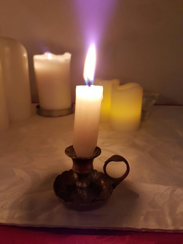 a lit candle sitting on top of a table