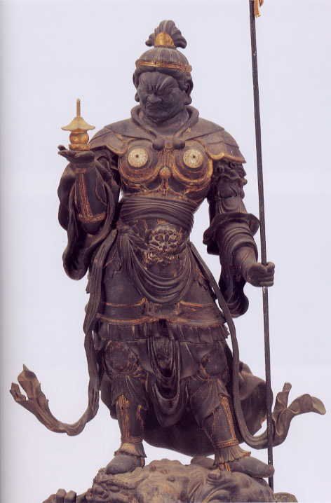 a statue of a man holding a staff